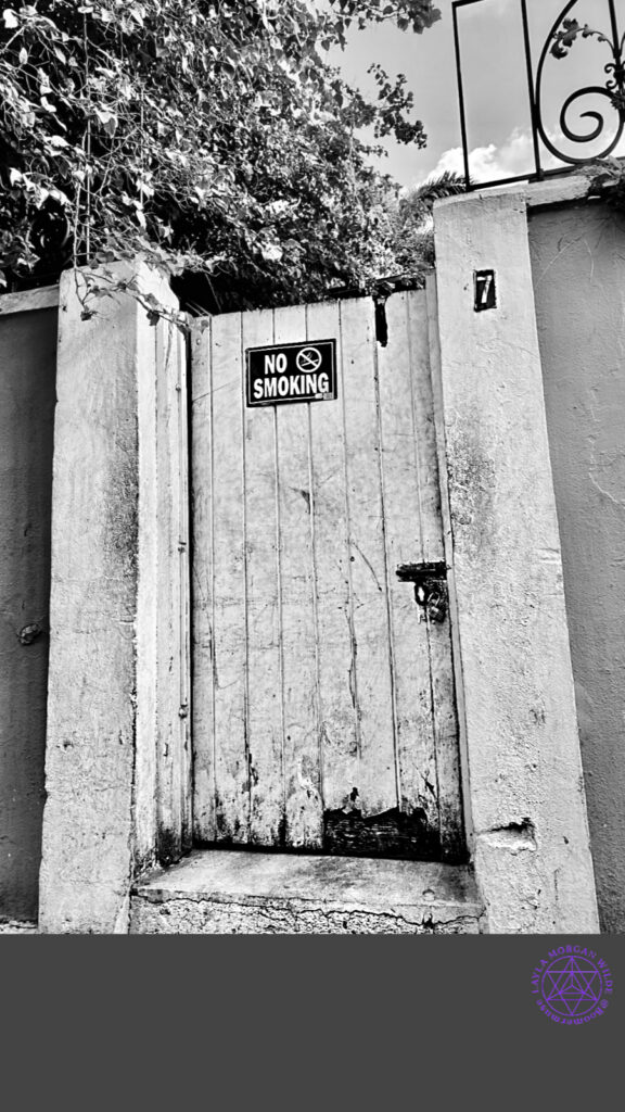  No smoking sign on a weathered outdoor door
